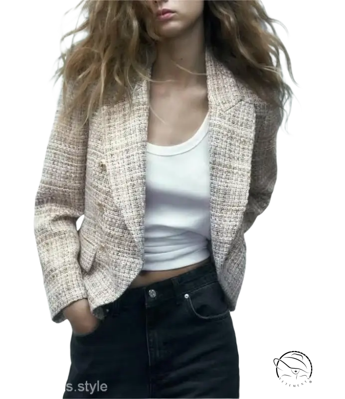 Textured beige loose houndstooth blazer styled over a white tank top and dark jeans