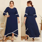 Navy blue maxi dress with white trim and flared sleeves.
