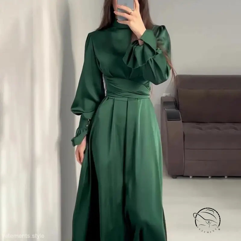 Elegant emerald green puff sleeve dress with cinched waist and high neckline