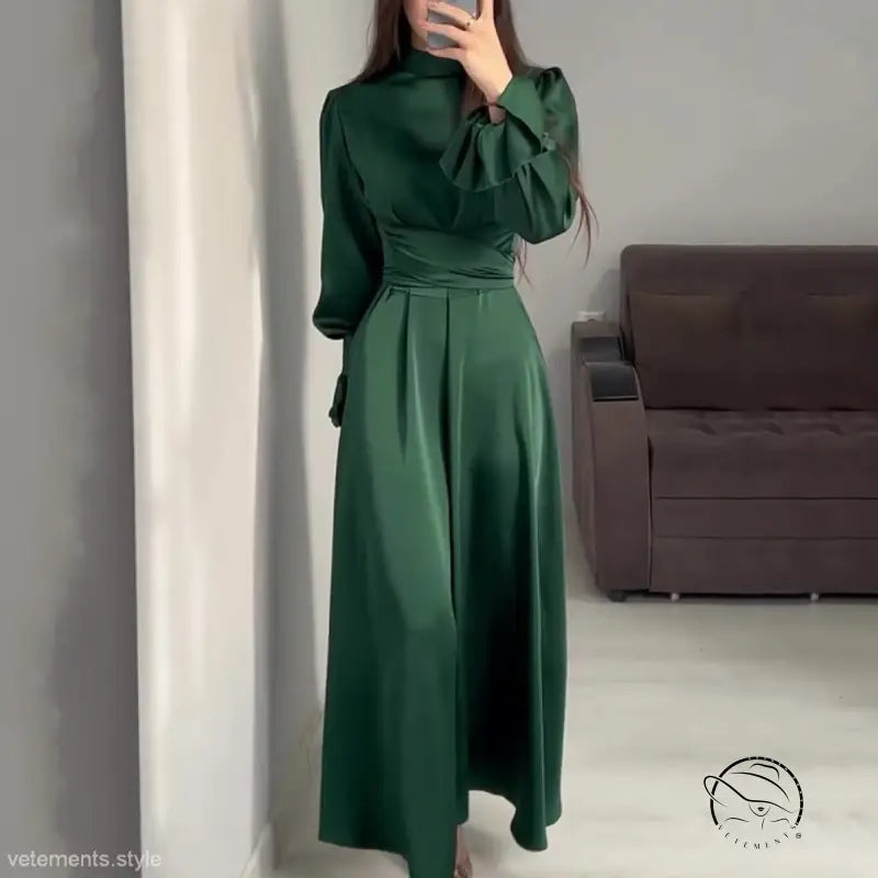 Elegant emerald green puff sleeve dress with a belted mock neck and cinched waist