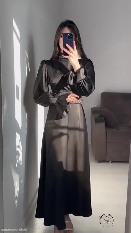 Elegant puff sleeve dress with billowy sleeves and cinched waist in a mirror selfie