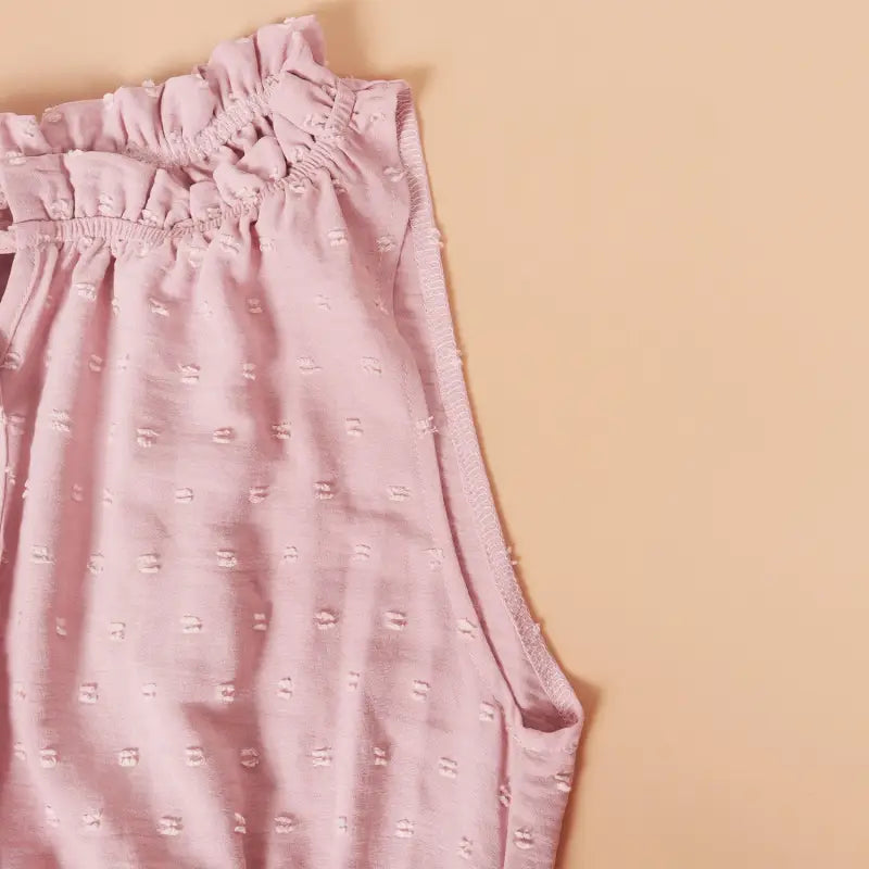Pink sleeveless blouse with ruffled neckline, ideal as a perfect vacation dress