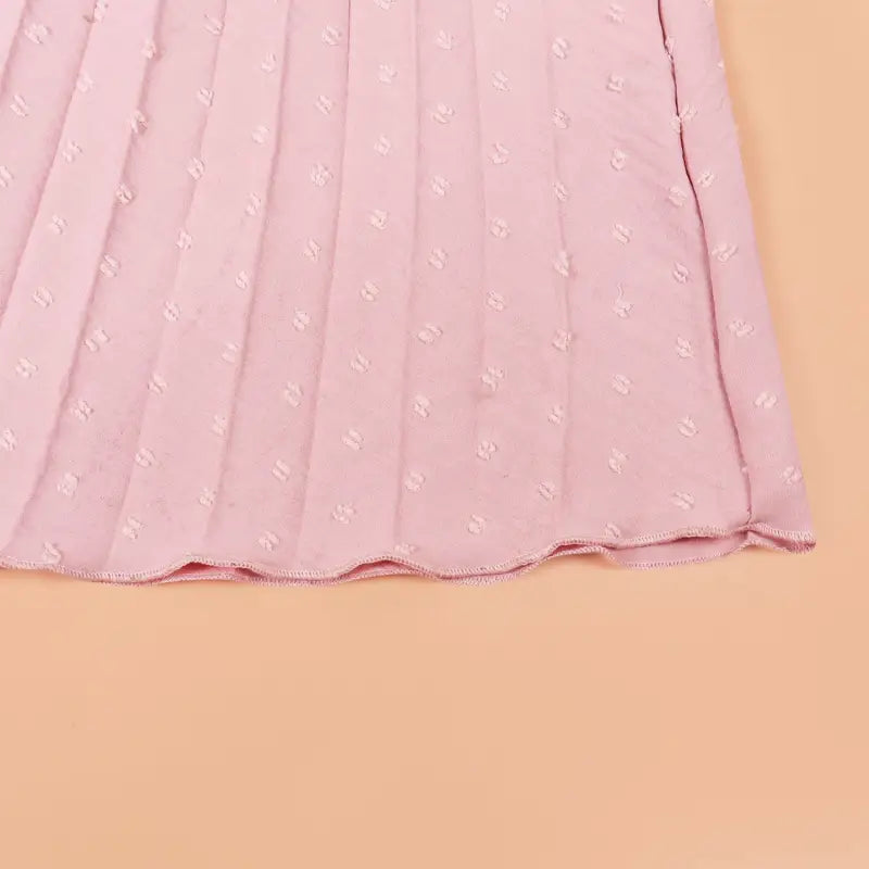 Pleated pink fabric with raised dots on elegant maxi dress, perfect vacation dress