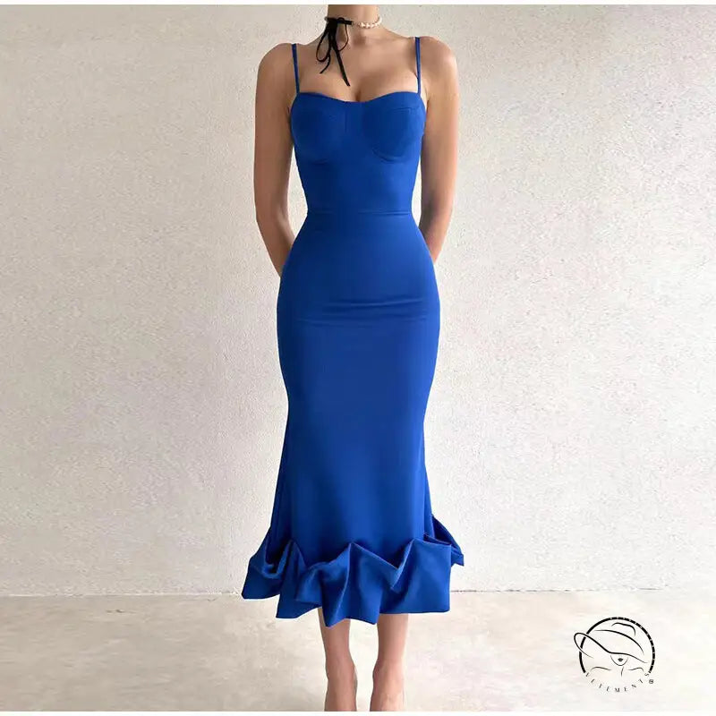 Vibrant blue form-fitting mermaid dress with spaghetti straps and a ruffled hem.