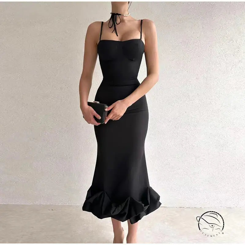 Elegant black mermaid-style dress with spaghetti straps and a ruffled hem.