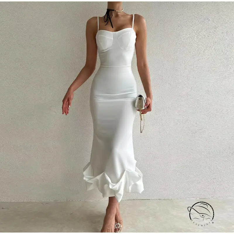Elegant white bodycon dress with spaghetti straps and a ruffled hem.