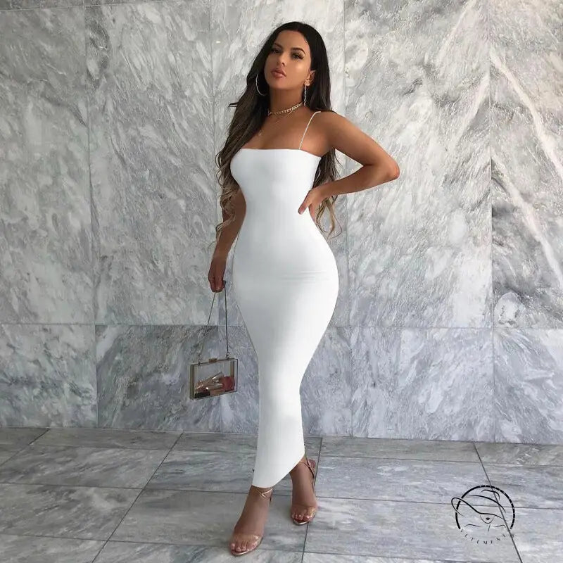 Woman in sexy sling maxi dress holding small handbag