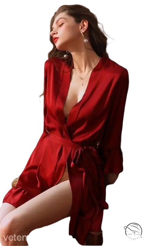 Woman in vibrant red sexy silk lotus dress with plunging neckline and belted sleeves