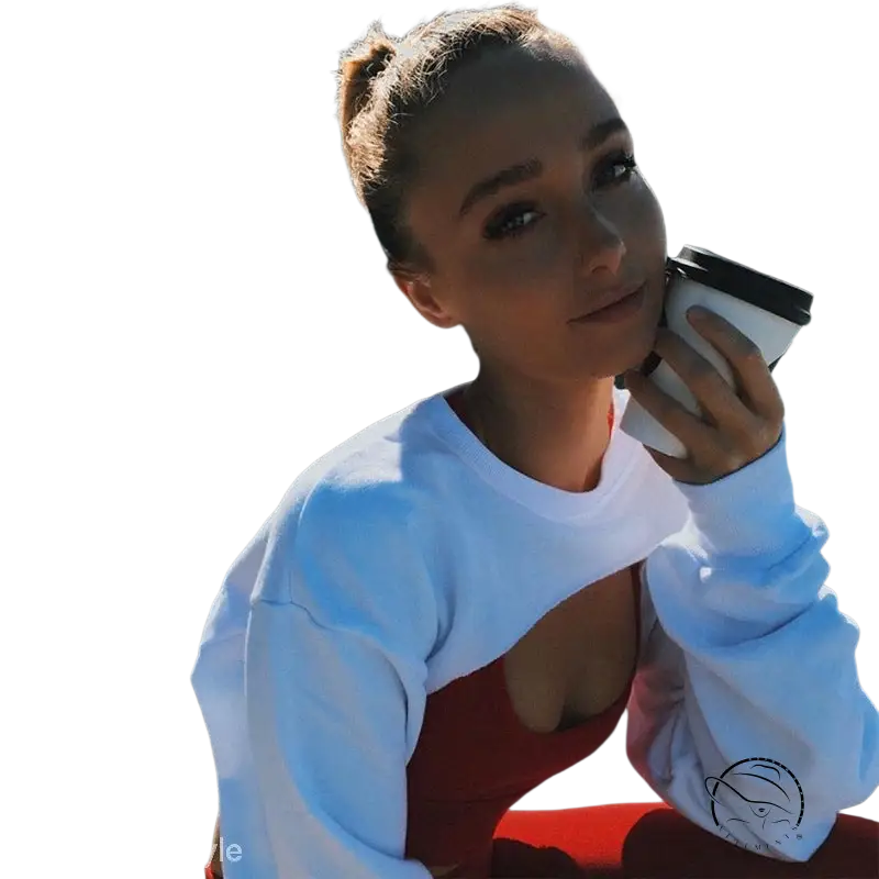 Young woman in fashionable fringes sweater holding coffee by waterfront