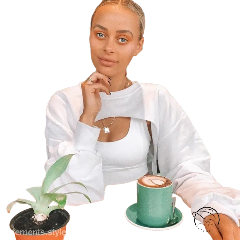Young blonde woman in fashionable fringes sweater at cafe with coffee
