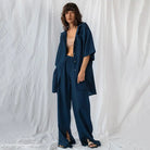 Woman in navy blue french cotton comfortable pajamas set with beige crop top for spring lounging