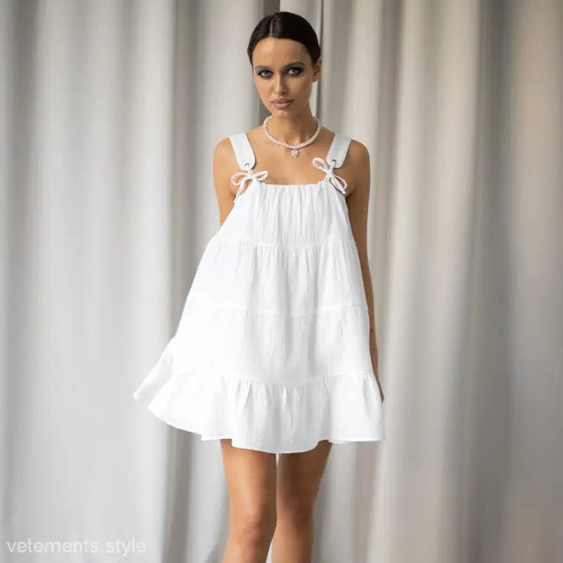 White sleeveless French nightdress pajamas with bow-tied straps and tiered flowy silhouette
