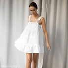 White sleeveless sundress with tie straps, flowy silhouette, perfect as a French nightdress pajamas
