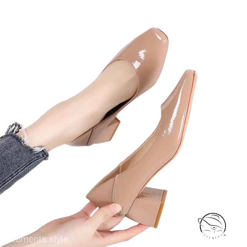 Pair of glossy nude patent leather low-heeled pumps in gorgeous high heel style