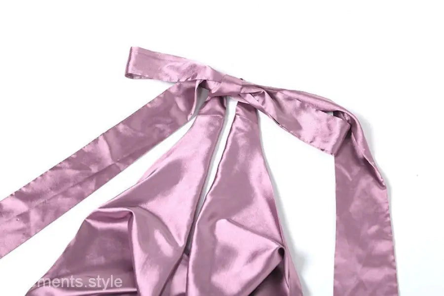 Pink satin ribbon or fabric tie with long trailing ends on high grade halter dress