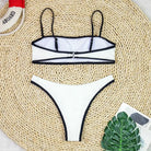 White bikini with black trim and spaghetti straps, ideal high waist sexy bikini for summer