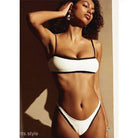 Model showcasing a high waist sexy bikini in white with black trim for summer fashion