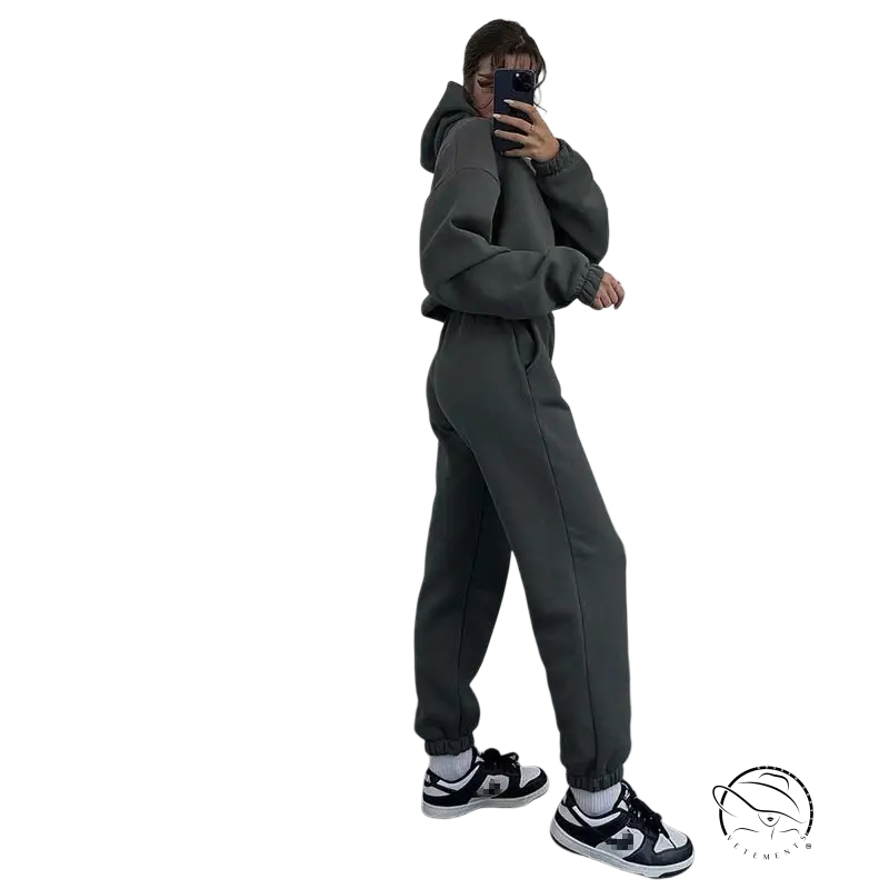 Person in hooded long sleeve sweater taking mirror selfie in gray sweatsuit and black-and-white sneakers for winter hooded casual wear