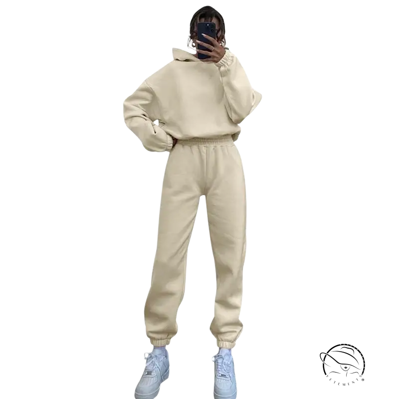Cream hooded long sleeve sweater with joggers and white sneakers for winter casual wear