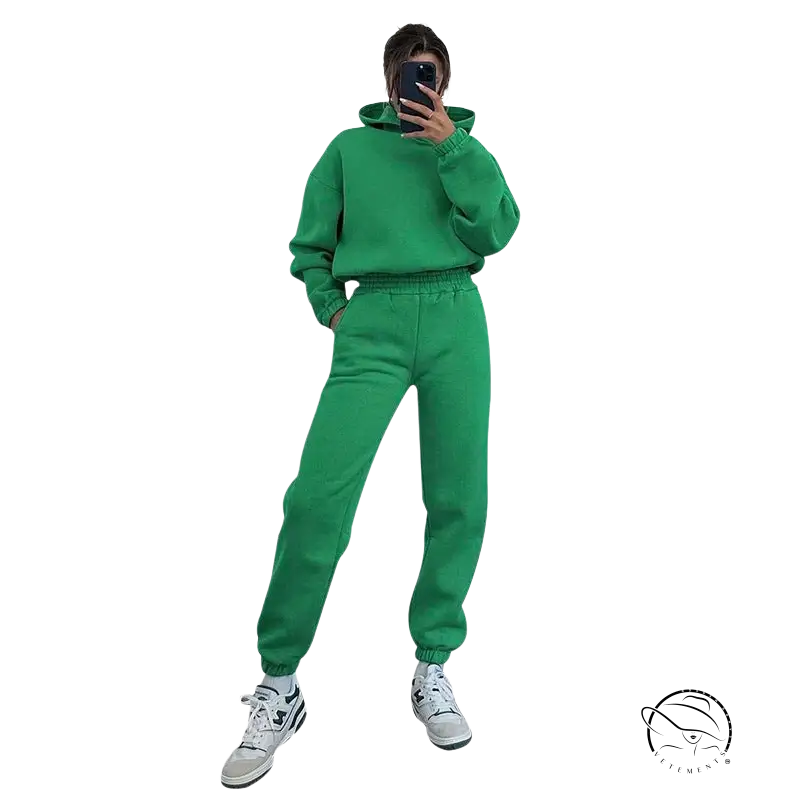 Bright green hooded long sleeve sweater with matching sweatpants and white sneakers for winter casual wear