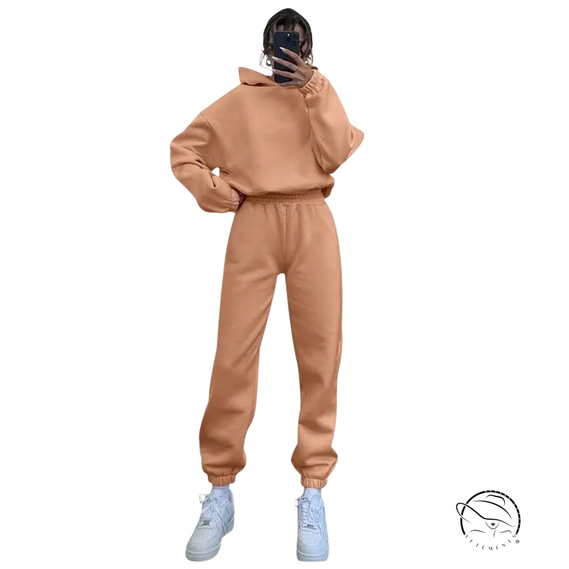 Peach hooded long sleeve sweater with matching joggers and white sneakers for winter casual wear