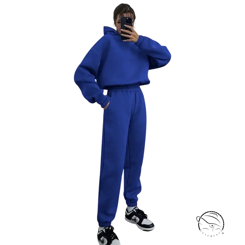 Person in hooded long sleeve sweater taking mirror selfie for winter casual wear