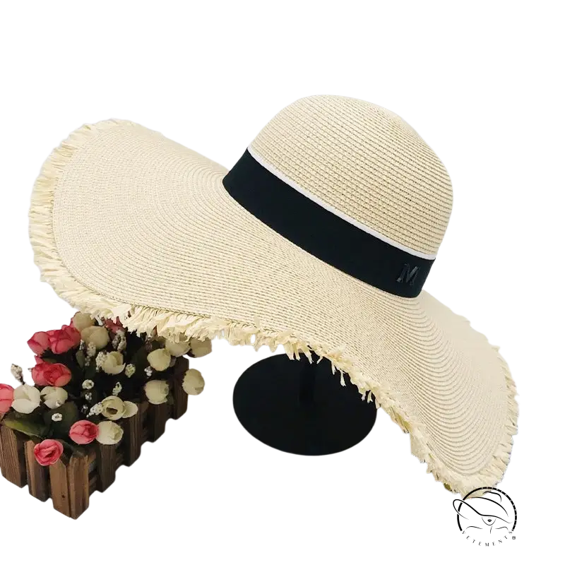 Lack of Color wide-brim sun hat with beige straw, black ribbon band and frayed brim