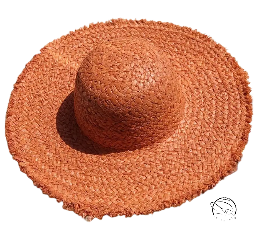 Woven orange straw broad brimmed hat with beige ribbon band by Lack Of Color