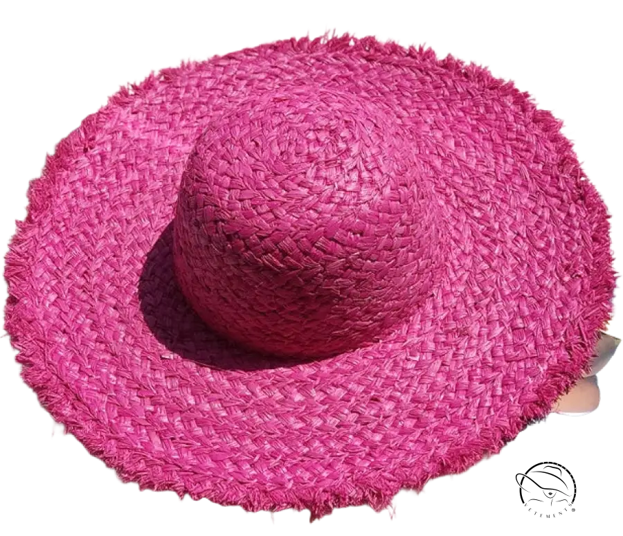 Vibrant fuchsia broad brimmed hat with wide brim, frayed edge, and beige ribbon band by Lack Of Color