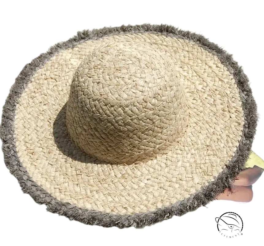 Lack of Color broad brimmed beige woven straw sun hat with frayed gray trim