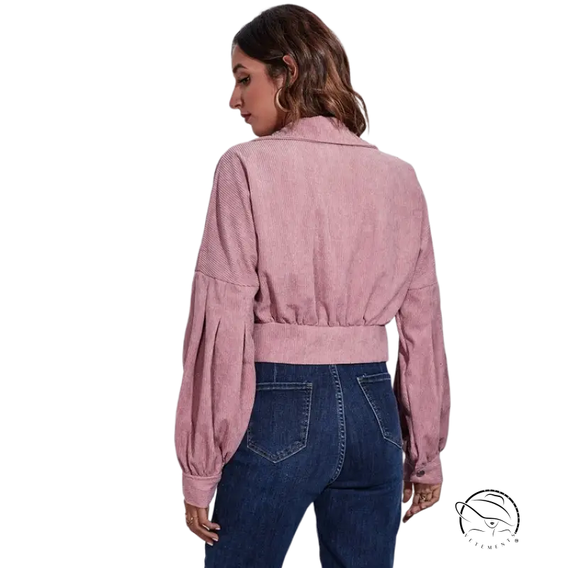 Pink lantern sleeve corduroy jacket with puffed sleeves over blue jeans