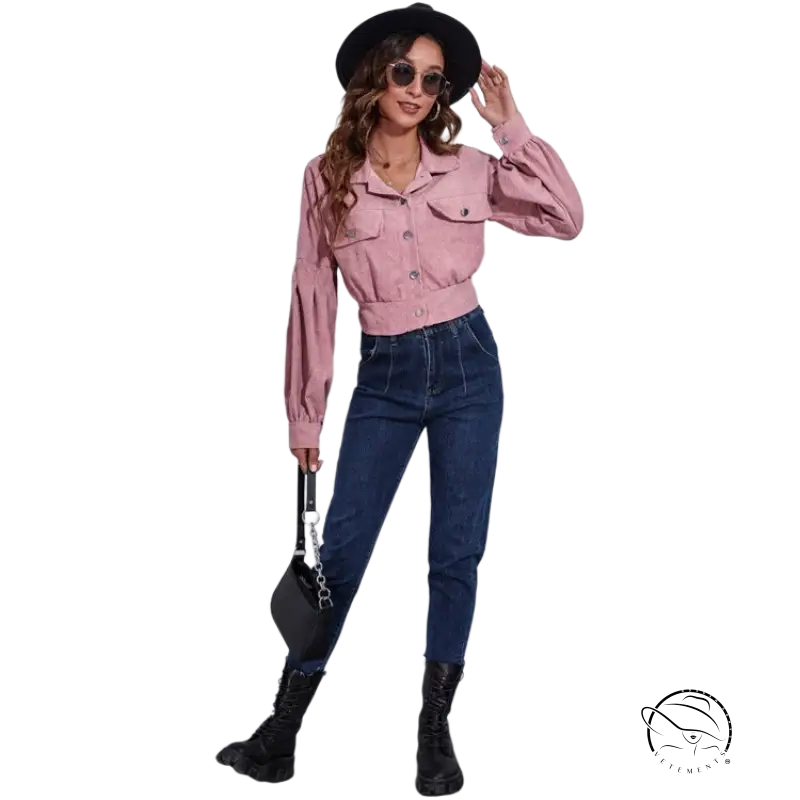 Woman in lantern sleeve corduroy jacket, pink cropped style, jeans, hat, sunglasses