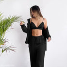 Woman modeling light brown three piece pajamas with collared shirt and long pants