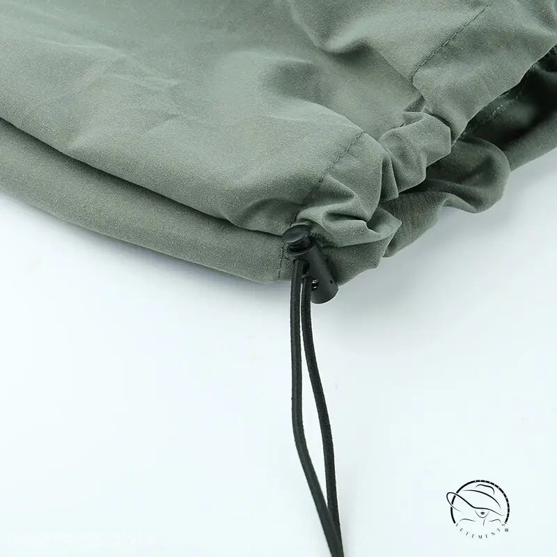 Drawstring closure on olive green fabric of light gray casual cute trousers