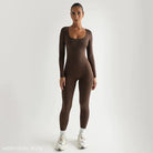Brown long-sleeved bodysuit styled with white sneakers, complementing a light gray soft jumpsuit