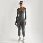 Woman wearing light gray soft jumpsuit with long sleeves and full-length legs