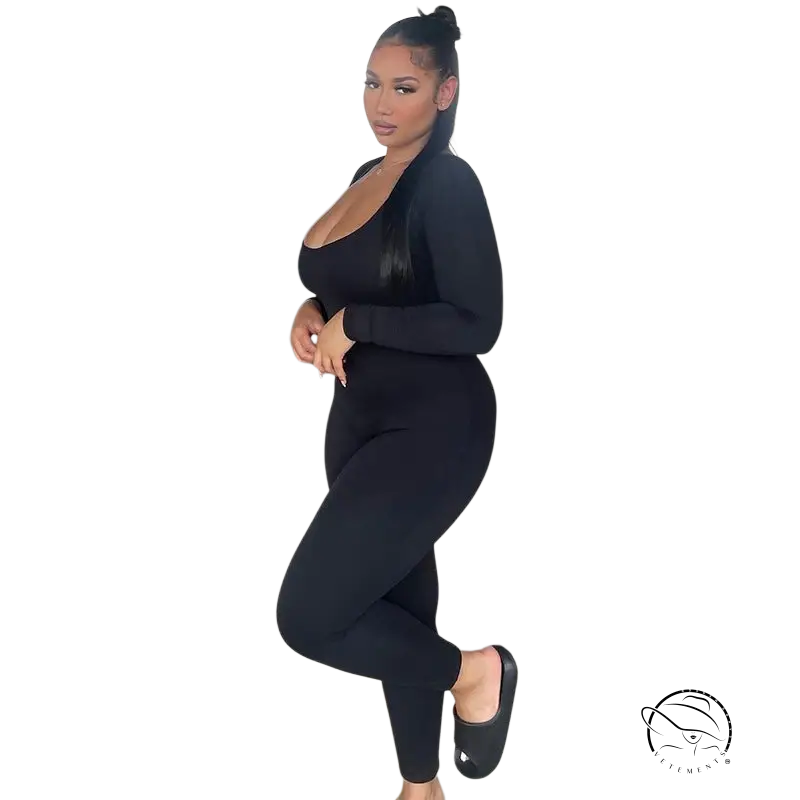 Woman in sexy soft jumpsuit posing in dark grey parking structure