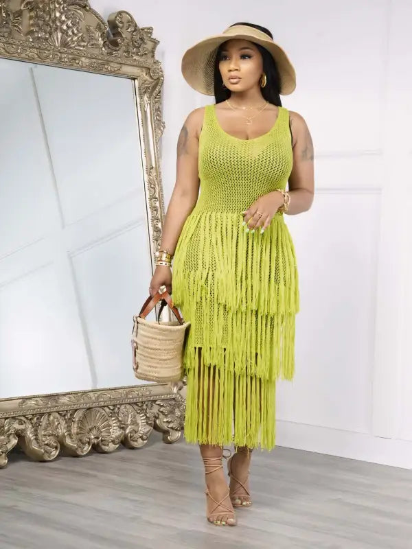 Woman in a light green knitted beach dress with elegant fringe detail