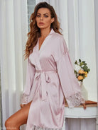 Silky pink robe with lace trim, perfect for elegant lounging in loose satin lace pajamas