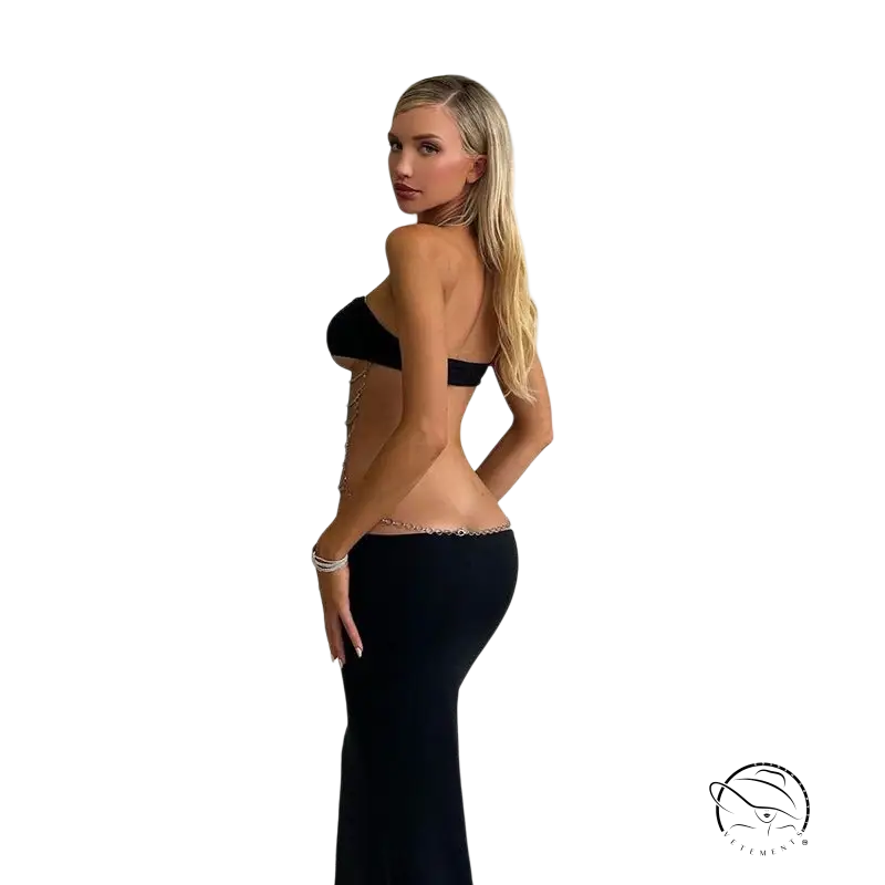 Woman in metal chain halter maxi dress with cutout design