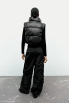 Black puffer vest and wide-leg pants paired with a Modern Short Faux Leather Jacket for winter