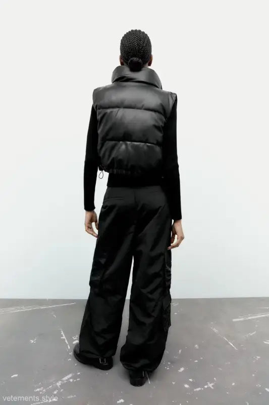 Black puffer vest and wide-leg pants paired with a Modern Short Faux Leather Jacket for winter