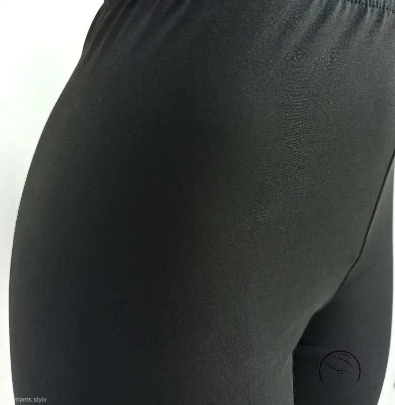 Black leggings paired with casual hoodie two piece set from hip view