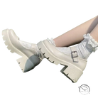 Cream-colored buckle platform heels with lace-up detailing and silver buckle