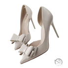 Elegant sweet high-heeled pumps in ivory patent leather with pointed toe and bow