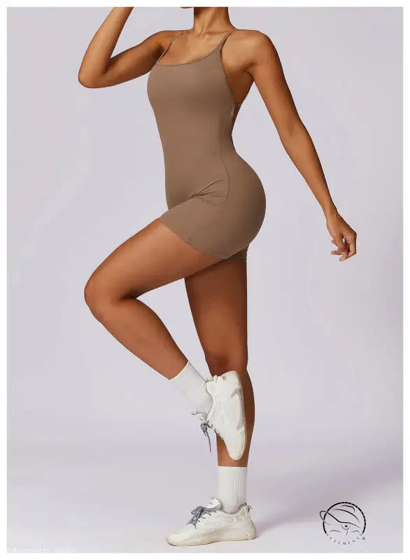 Beige strappy quick drying nude feel sports bodysuit with white socks and sneakers