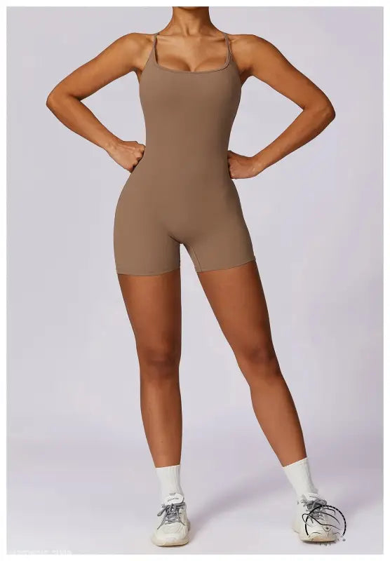 Beige quick drying nude feel sports bodysuit with thin straps and white socks