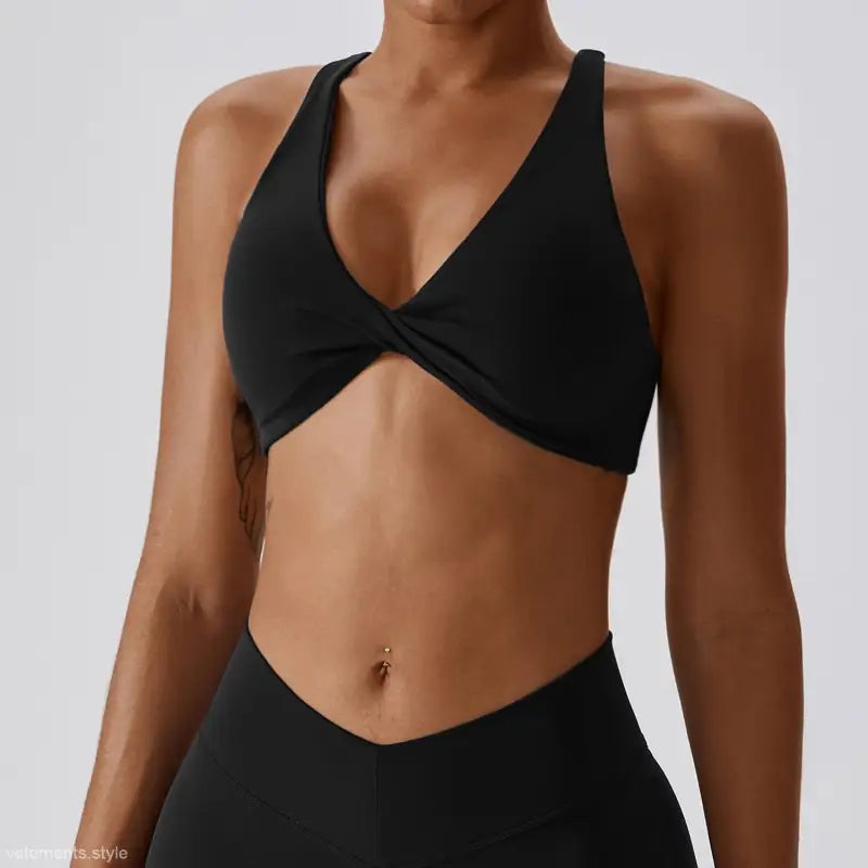 Black twisted-front sports bra in dark reddish purple and tropical orange for quick drying yoga