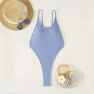 Light blue one-piece swimsuit with thin straps, featuring a royal blue backless design