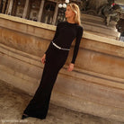 Elegant backless maxi dress featuring a fitted silhouette and decorative circular belt